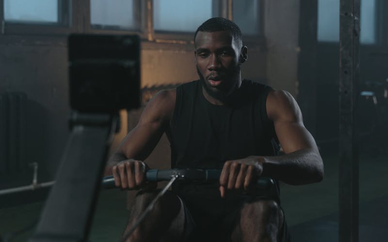 Person using a rowing machine in a gym